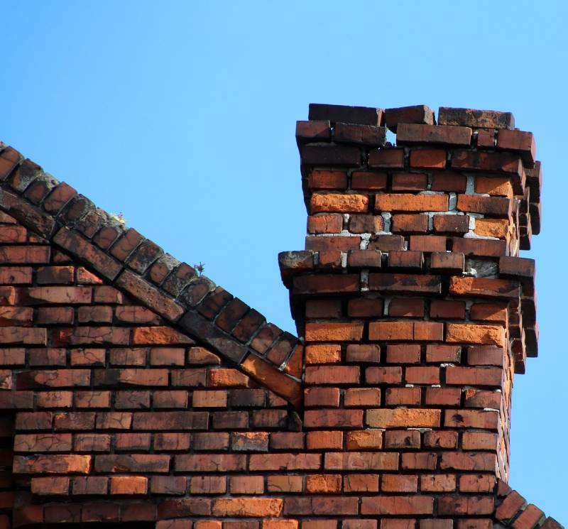 Signs Your Barrington Home Needs a Chimney Inspection Damaged chimney on an Barrington home showing cracks and missing mortar